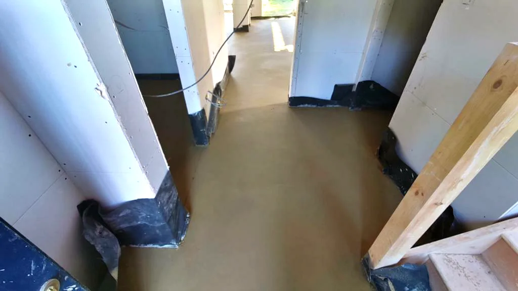 Wide view of a finished screed hallway in a timber framed build