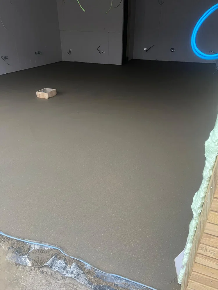 Freshly laid floor screed under site lighting