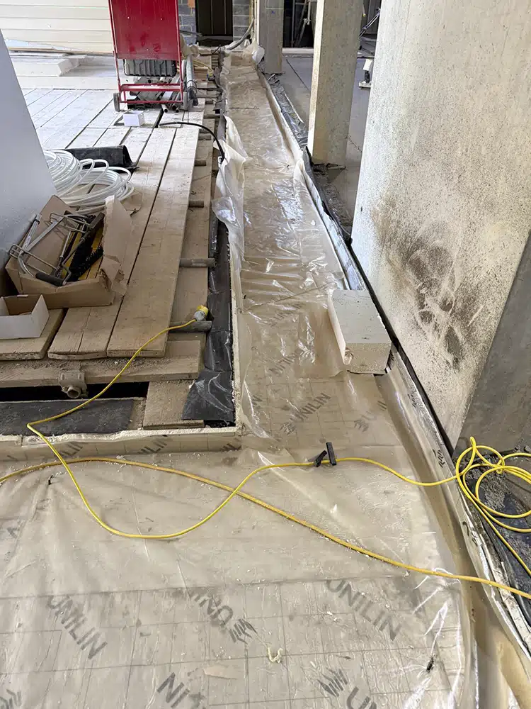 Subfloor with membrane and services laid out before screeding