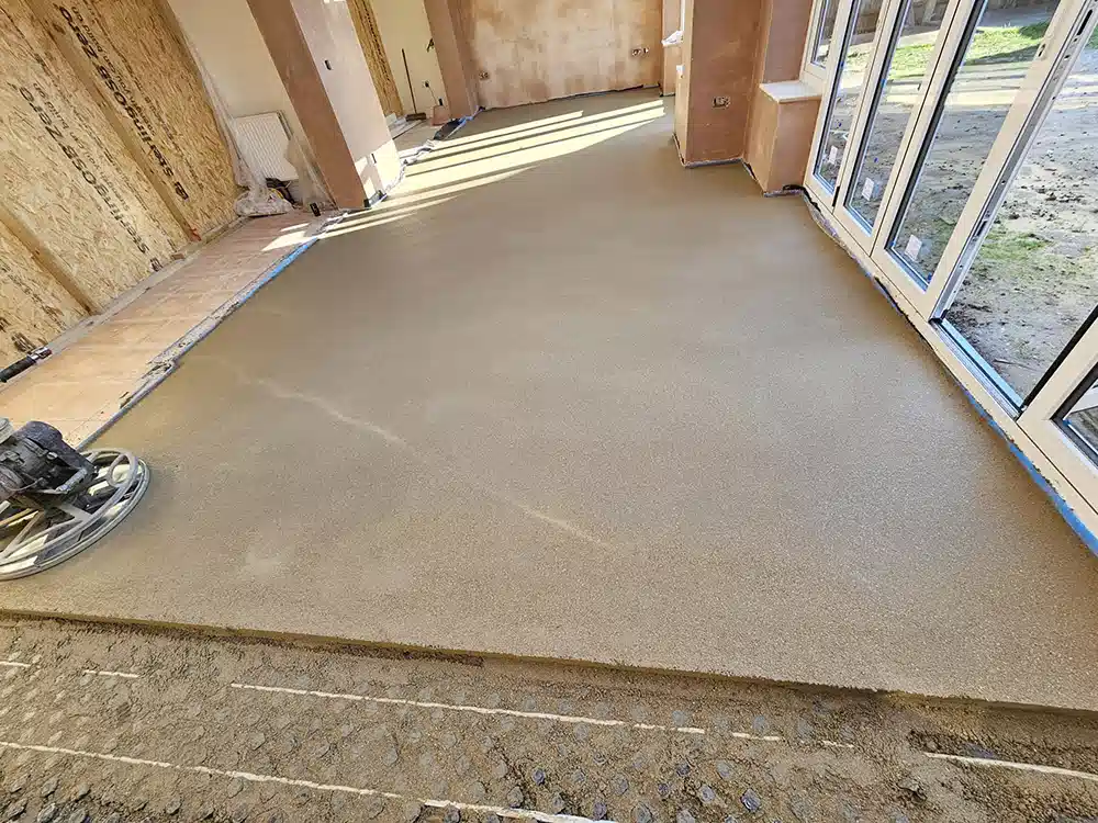 Power float finishing a large sand and cement screed