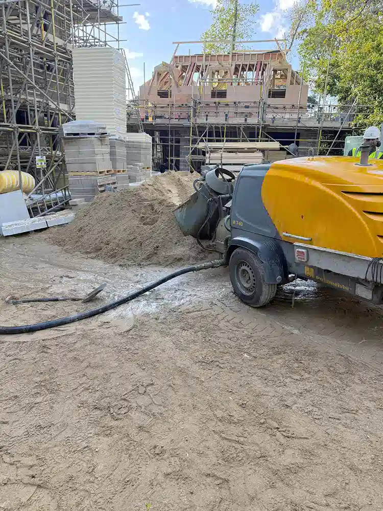 Screed pump set up on site for a floor screeding job