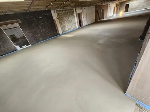Wide commercial floor screed laid across a large building