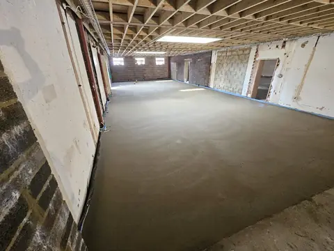 Large commercial floor screed under a timber roof