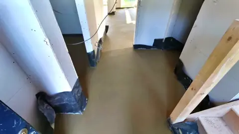 Wide view of a finished screed hallway in a timber framed build