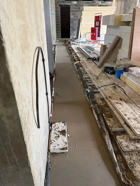 Corridor mid screed with timber formwork and edge detailing