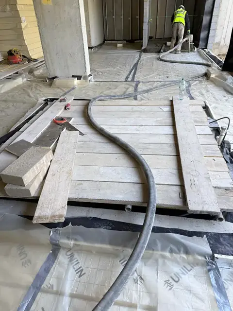 Floor preparation with boards and screed hose before a pour