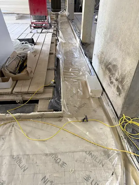 Subfloor with membrane and services laid out before screeding