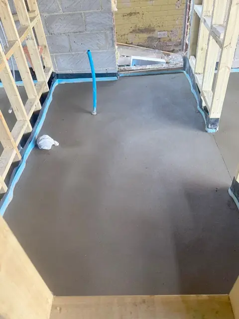 Room prepared with blue edge strip and membrane ready for screed