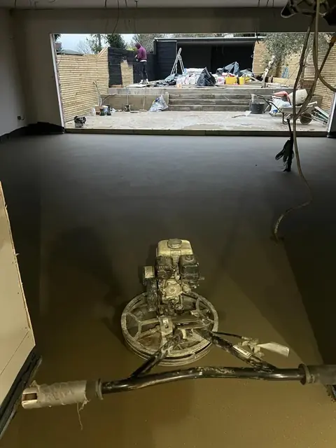 Power float on a freshly finished sand and cement screed