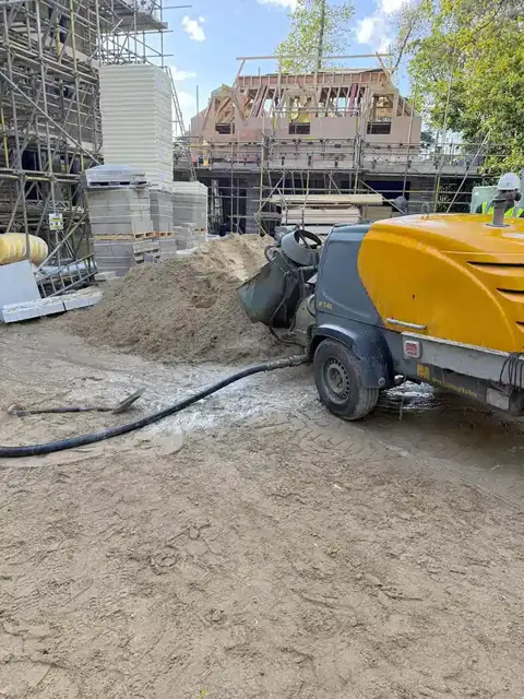 Screed pump set up on site for a floor screeding job