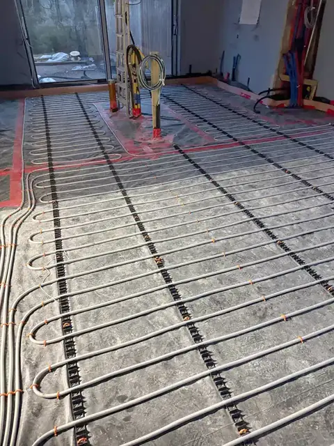 Underfloor heating loops marked out in red before floor screeding