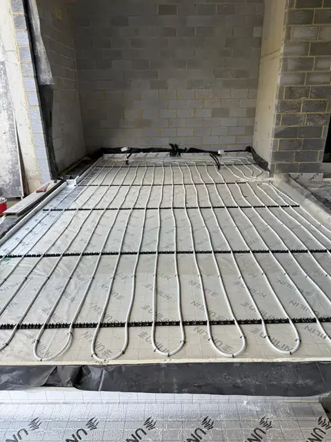 Grid of underfloor heating pipework ready for a screed pour