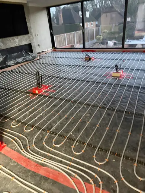 Underfloor heating loops laid in a glazed room before the screed