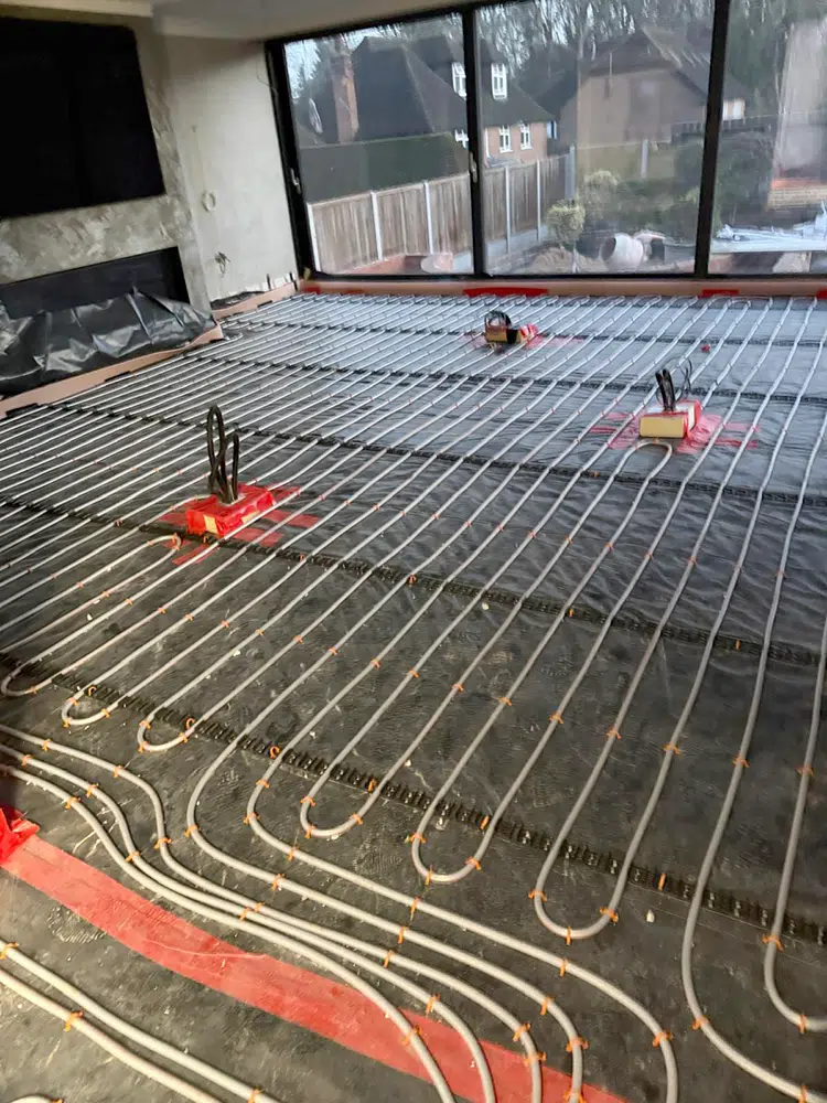 Underfloor heating loops laid in a glazed room before the screed